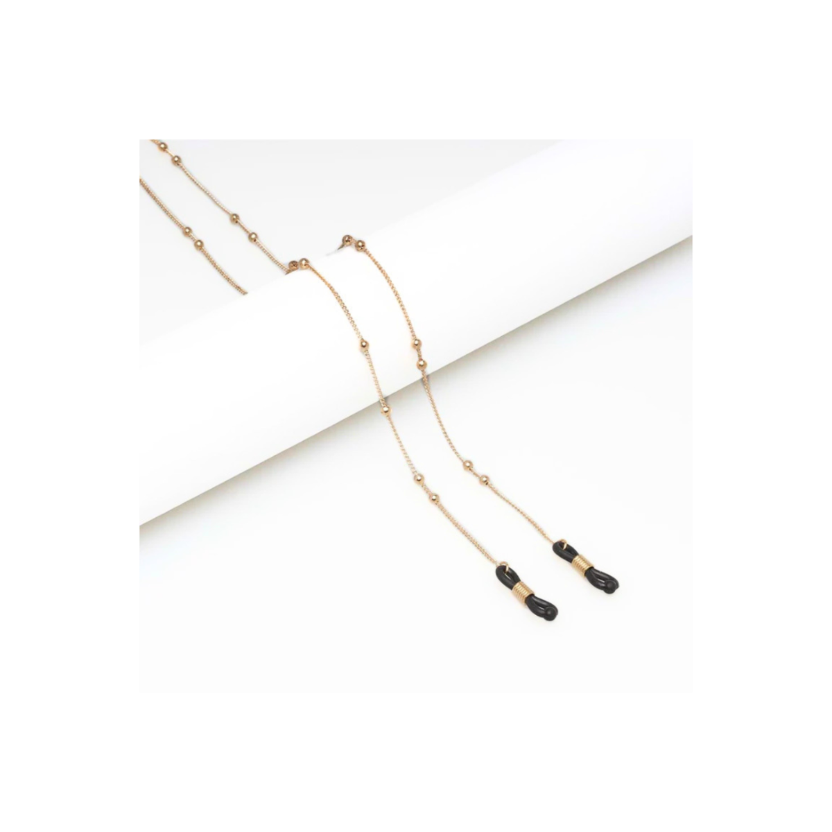 Gold necklace with black accents on a white background